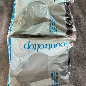 New with tags. 2 pairs of black nylon control top stockings.
